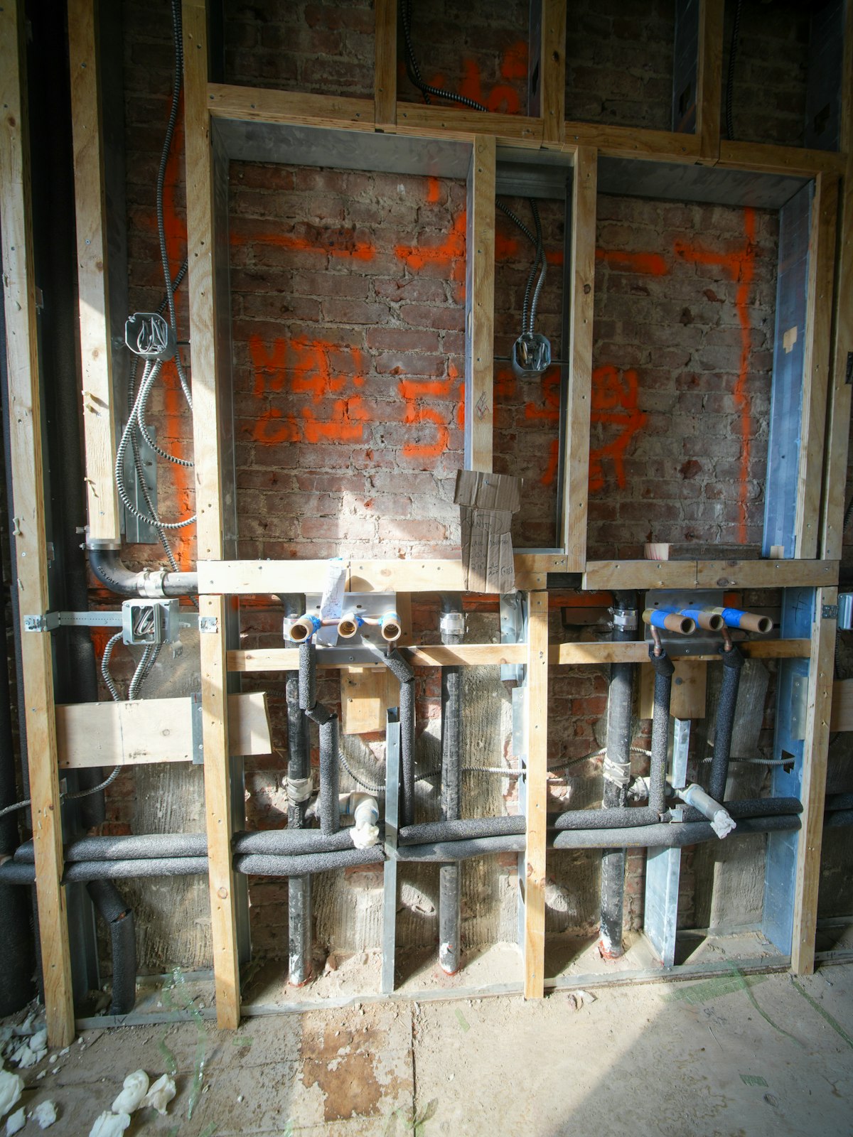Plumbing pipework inside a wall under construction